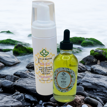 facial oil and face wash on ocean rocks